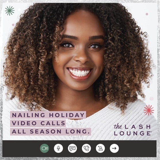 black woman with lash extensions smiling while on a video call