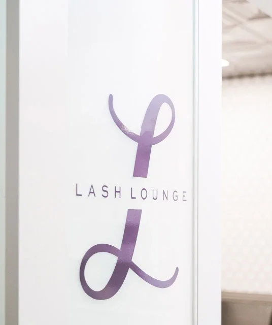 The Lash Lounge logo on front door of salon
