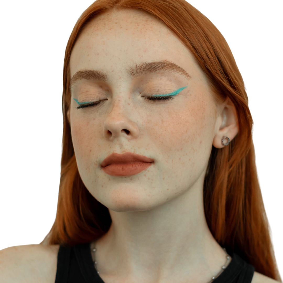 young red head woman with closed eyes to show her neon blue eyeliner