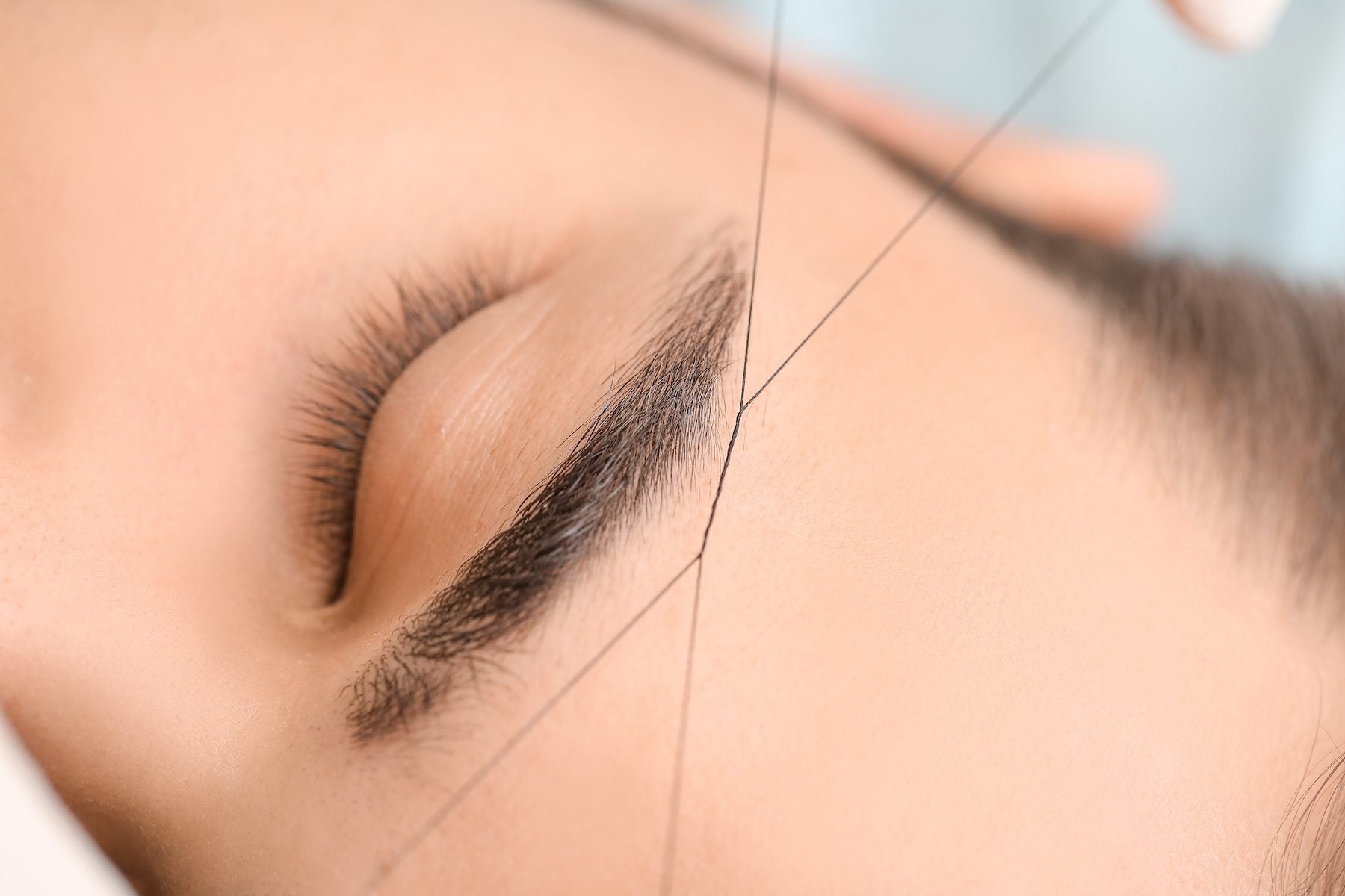 close-up of woman having her eyebrows threaded