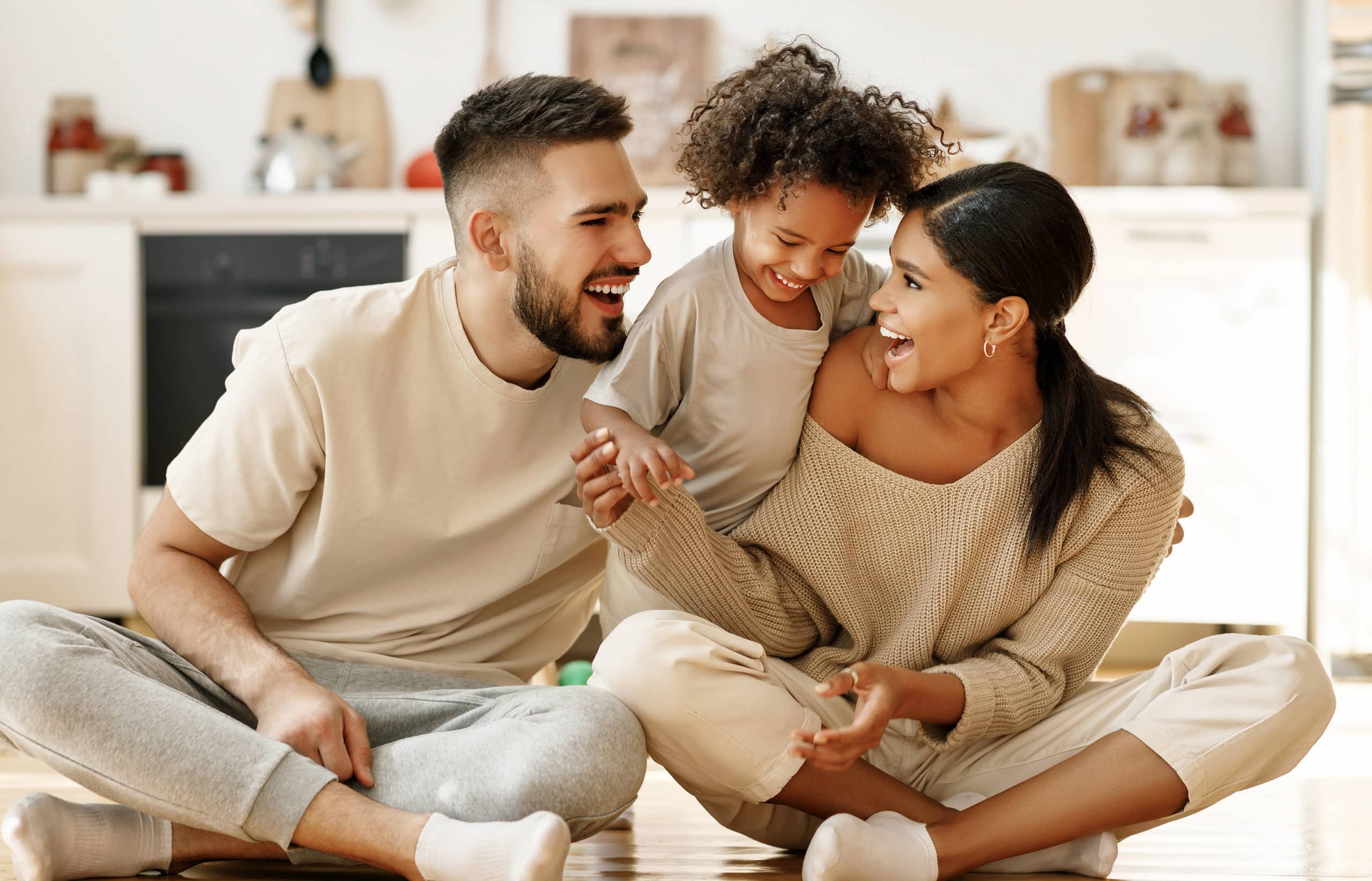 Parents and a child smiling and spending time together during the holiday season