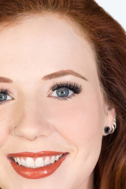 Zoomed in image of a women showing off her new eyelash extensions.
