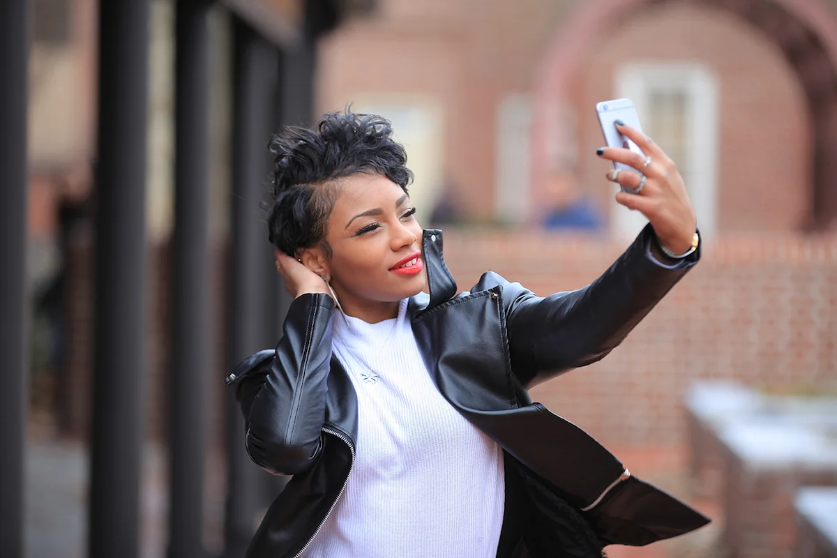 black woman with lash extensions on a video call