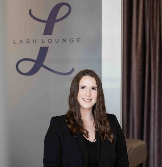 Woman in all black sitting in lobby of The Lash Lounge