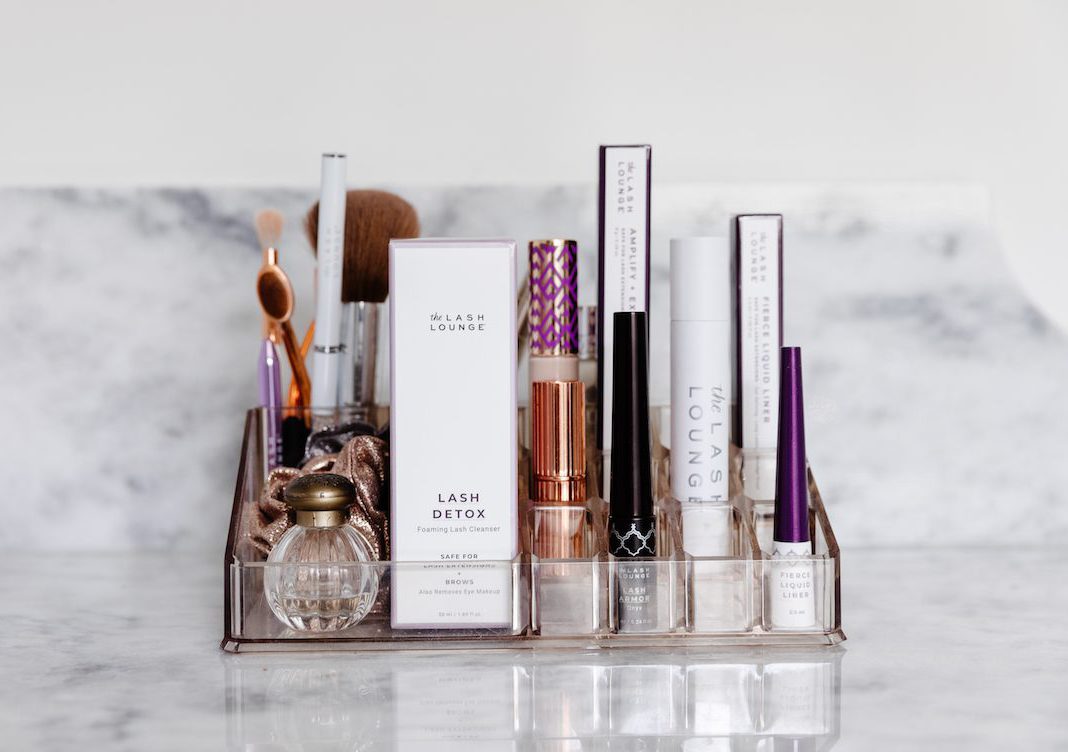 array of beauty products and cosmetics on bathroom counter