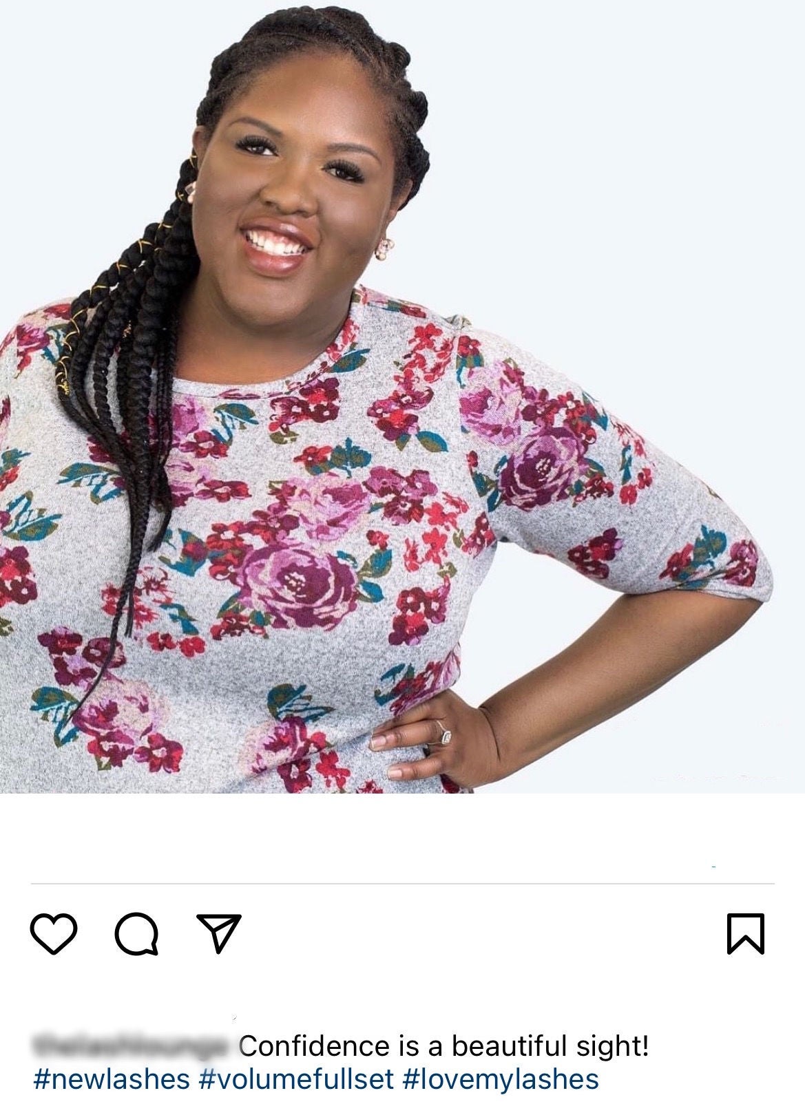 mid-shot of black woman in floral shirt with lash extensions