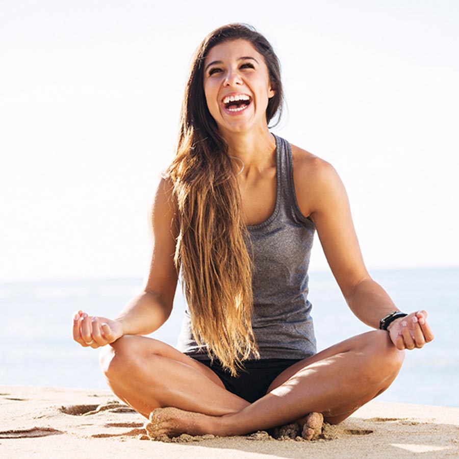 woman meditating on beach after eyebrow threading