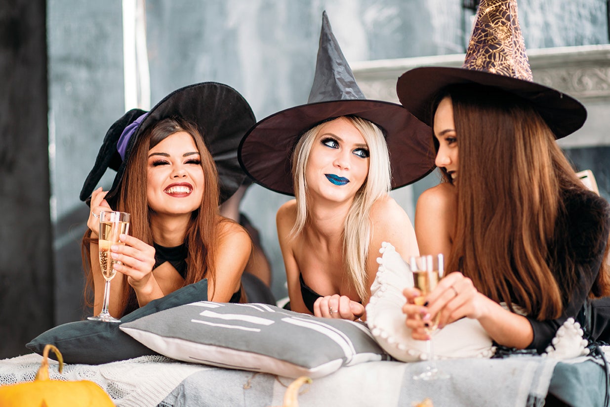a group of friends dressed up for halloween, laughing together