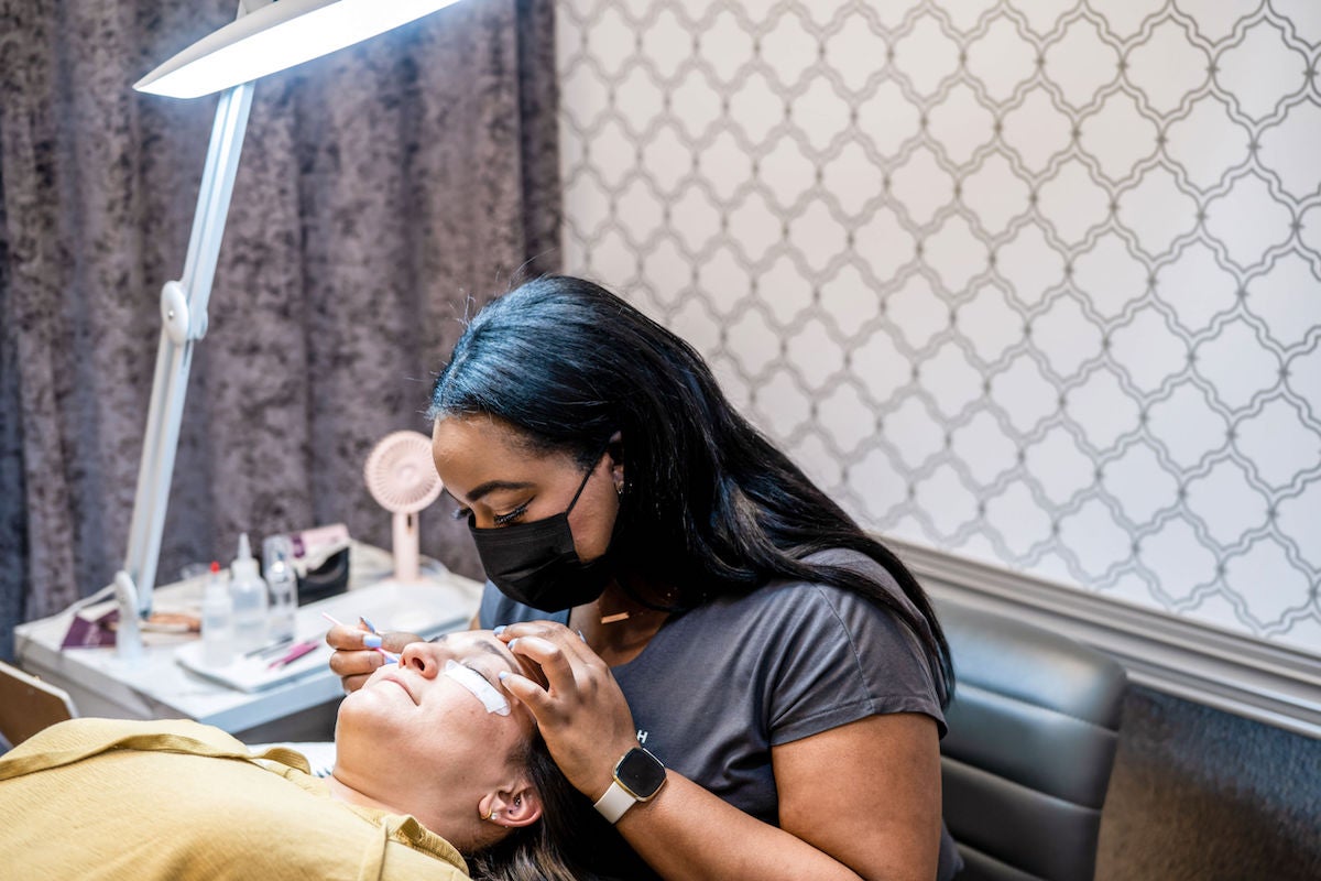 Lash stylist performing a lash application