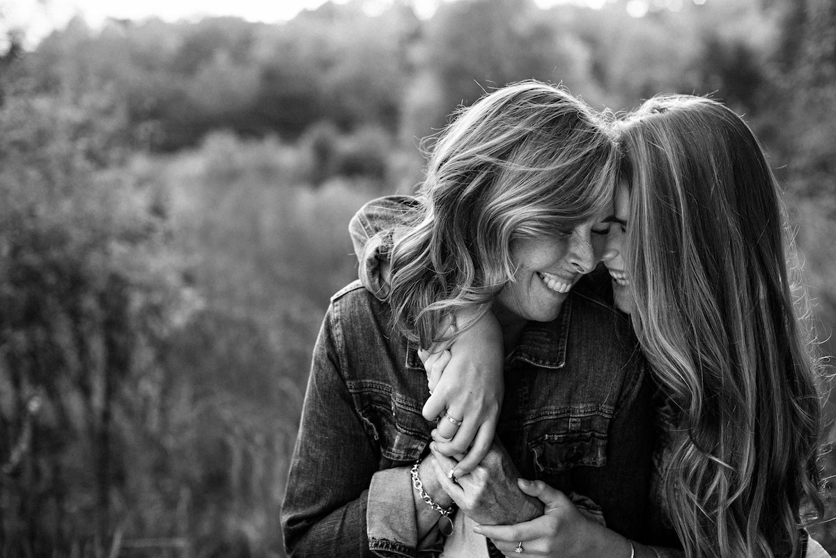 black and white photo of mother and grown daughter hugging