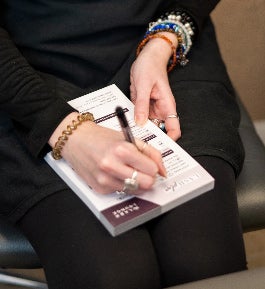 Lash Lounge stylist writing down Lash Plan design details.