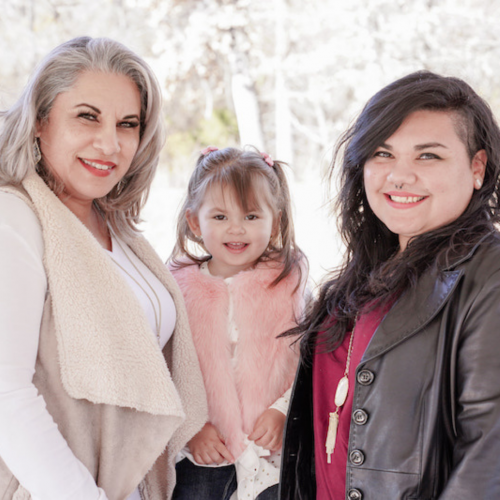 grandmother, granddaughter and daughter pictured together outdoors wearing sweaters and jackets