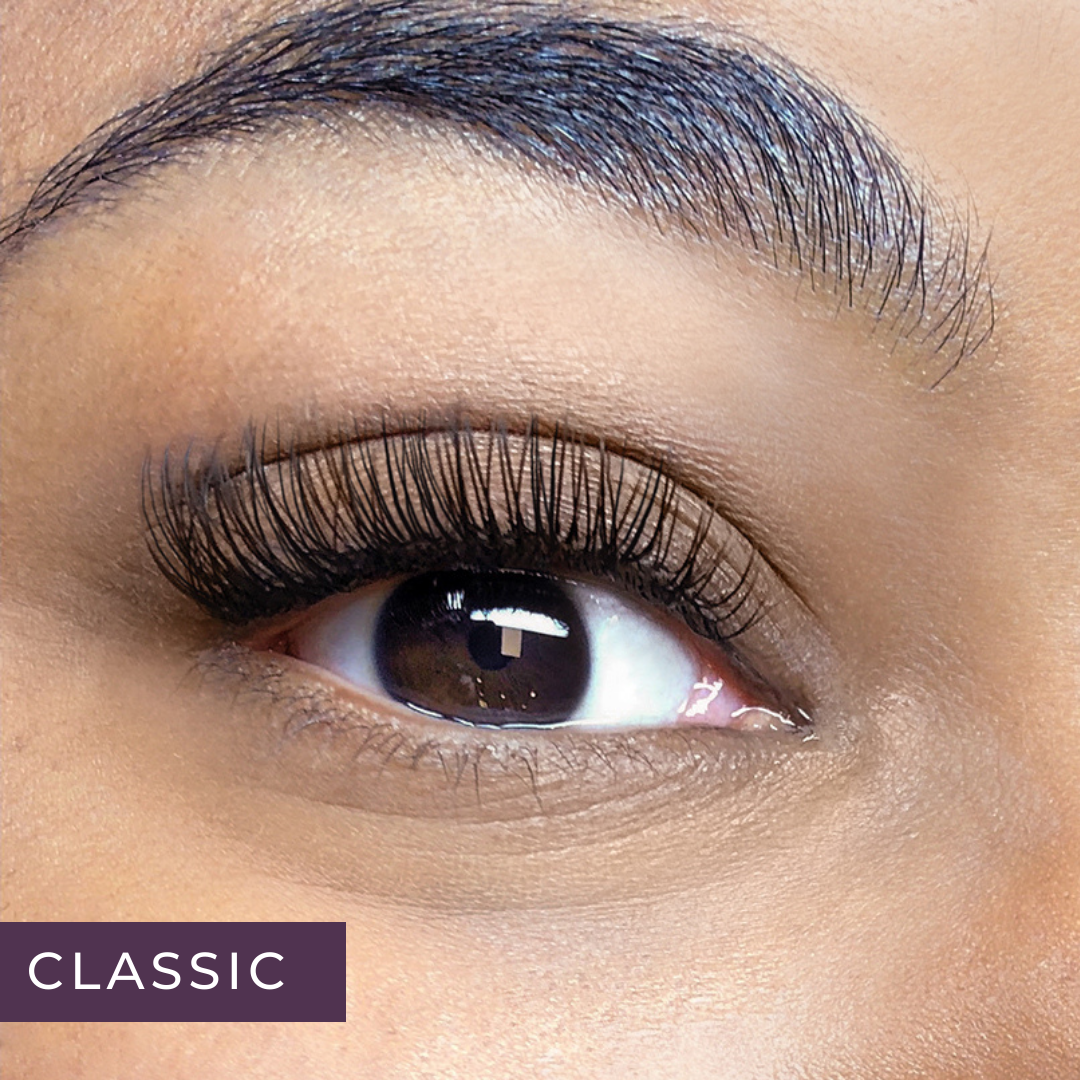 close-up of woman's brown eye with a full set of classic lash extensions