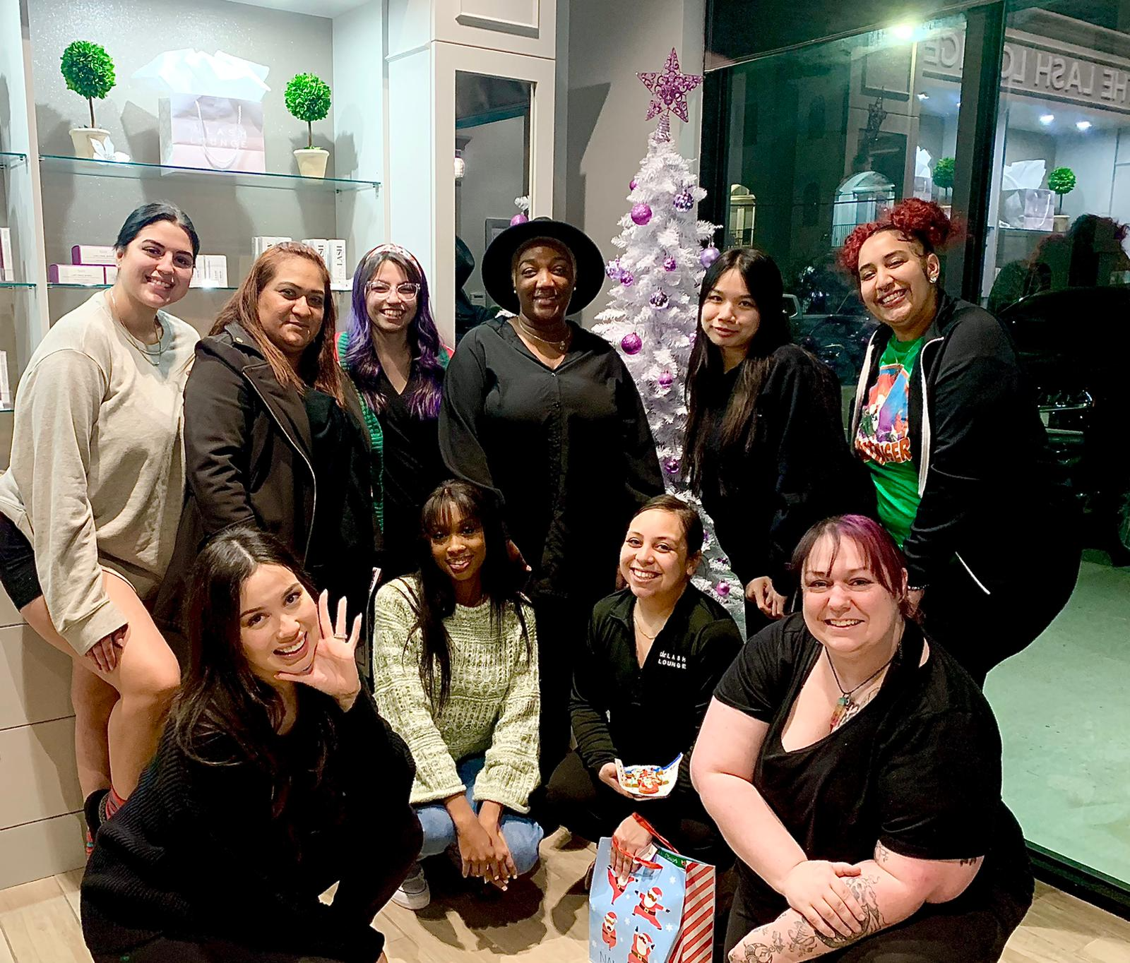 Salon team in lobby in front of Christmas tree