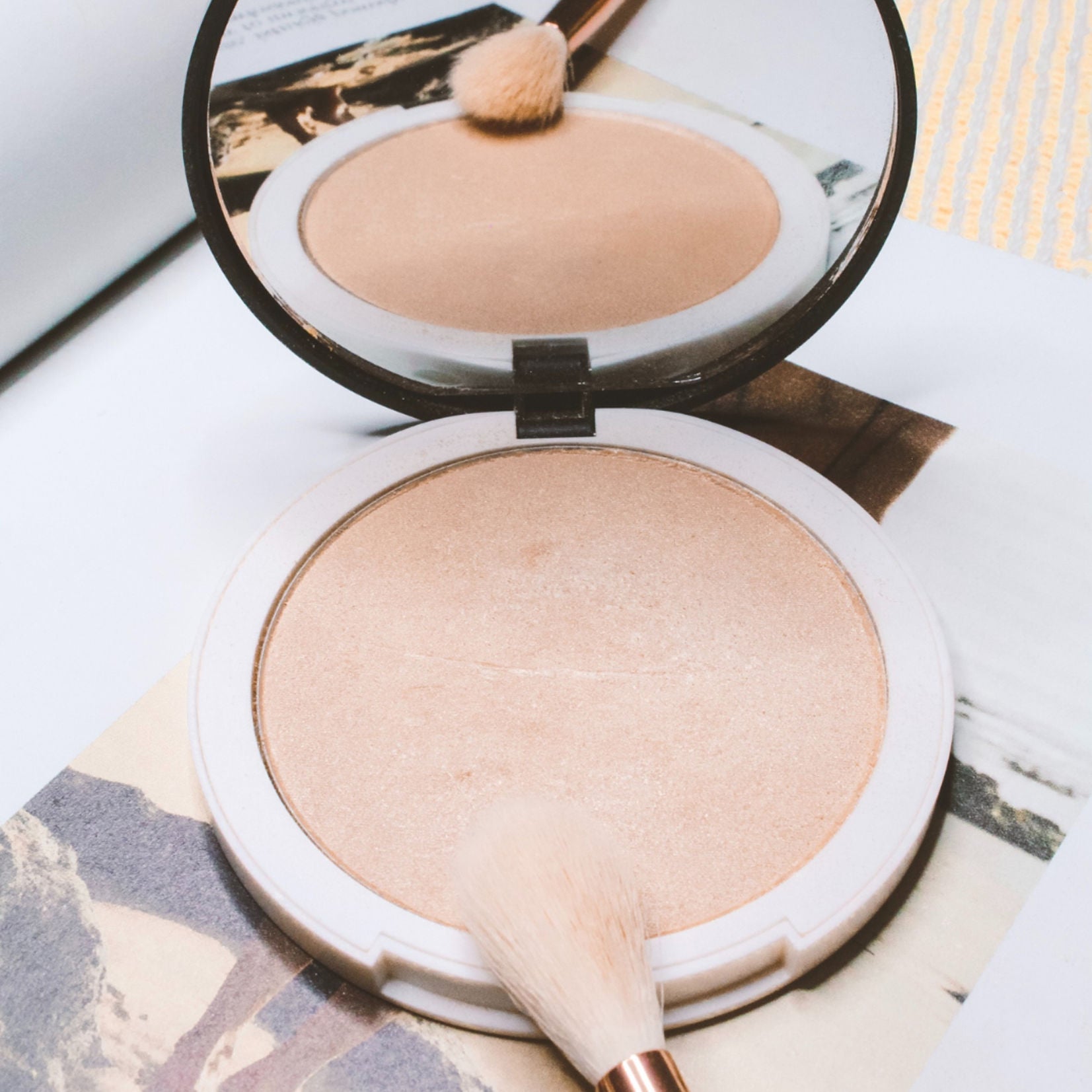 makeup powder highlighter compact open with brush