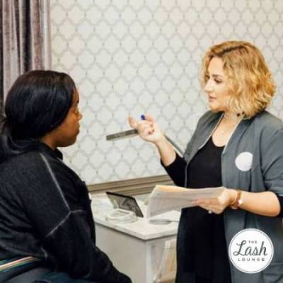 Stylist giving the 4-step eyelash extension consultation process at The Lash Lounge to a guest