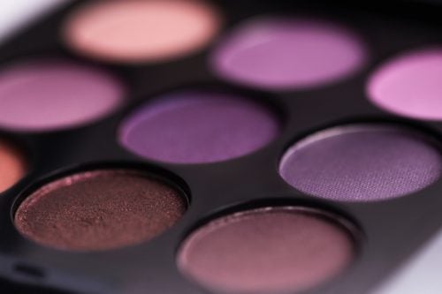 an eyeshadow palette containing shades of purple