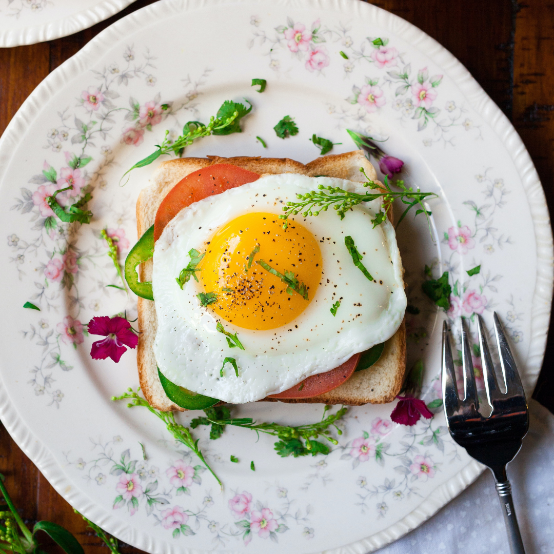 floral plate with breakfast and sunny side up egg
