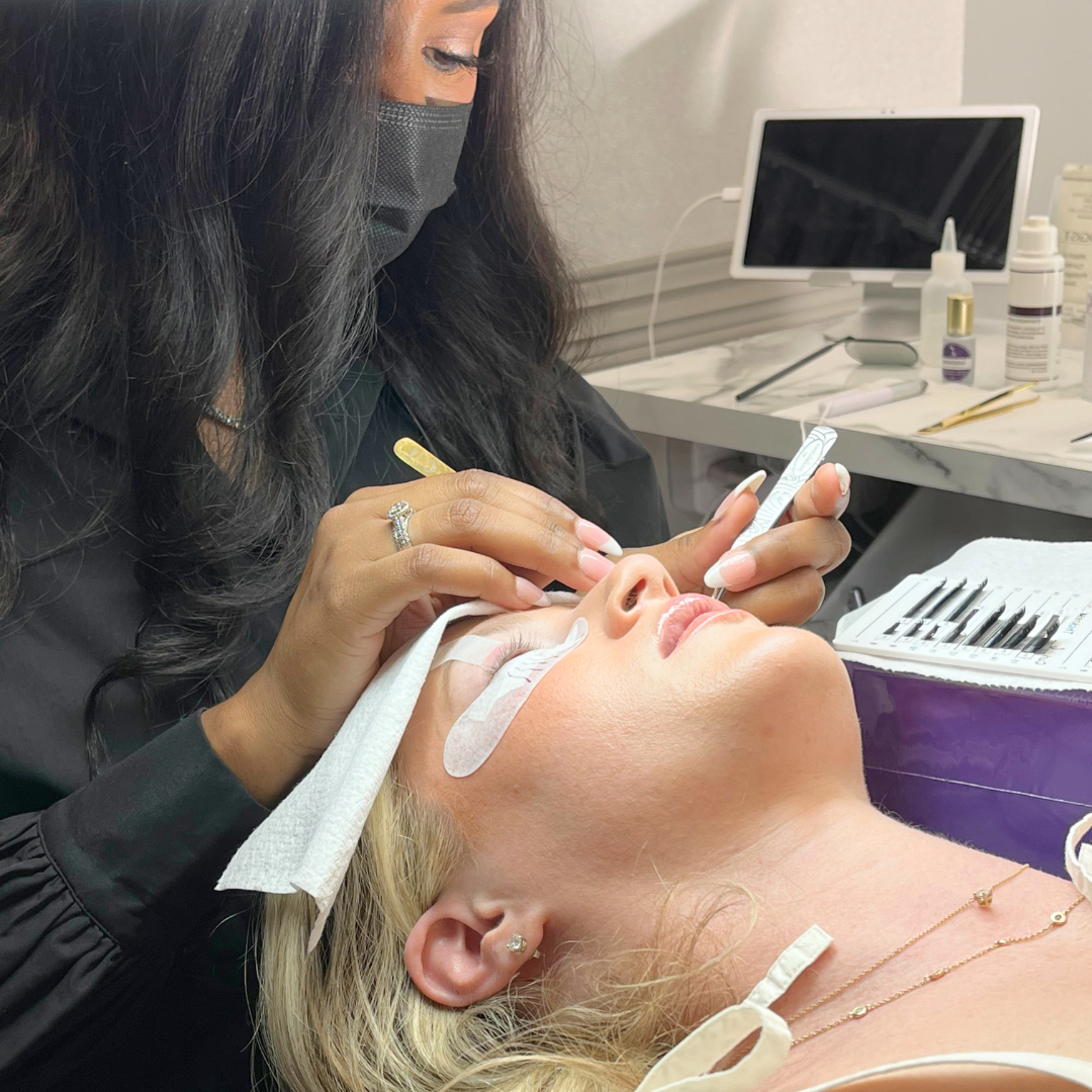 woman laying down during a lash refill appointment