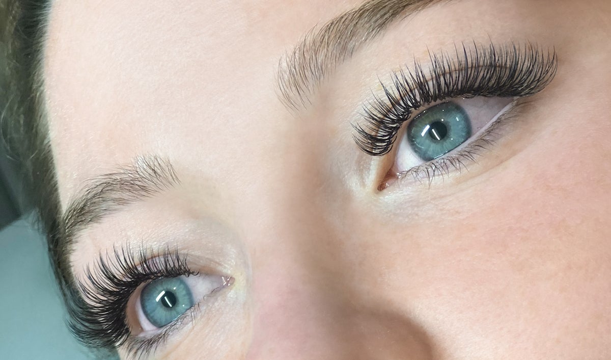 full set of classic lash extensions on woman with blue eyes