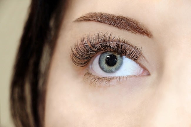 an extreme closeup of a woman's eye that has lash extensions applied from The Lash Lounge