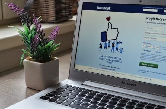 a close up of a laptop with the Facebook social networking site displayed on the screen