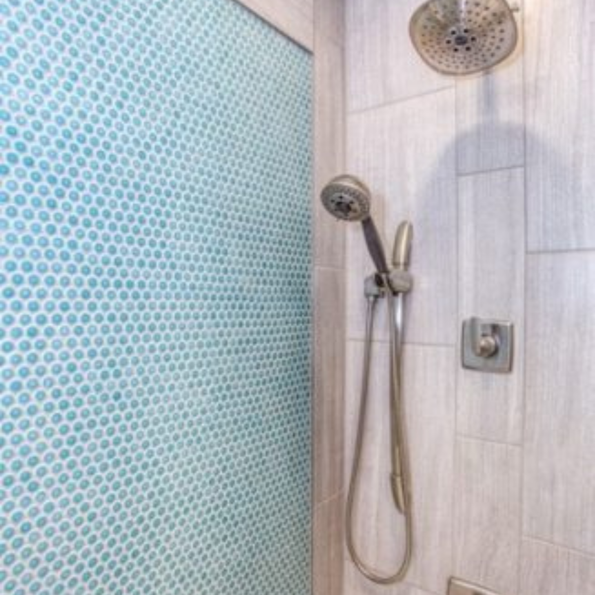Shower tile on the back wall and tile behind faucet and shower head
