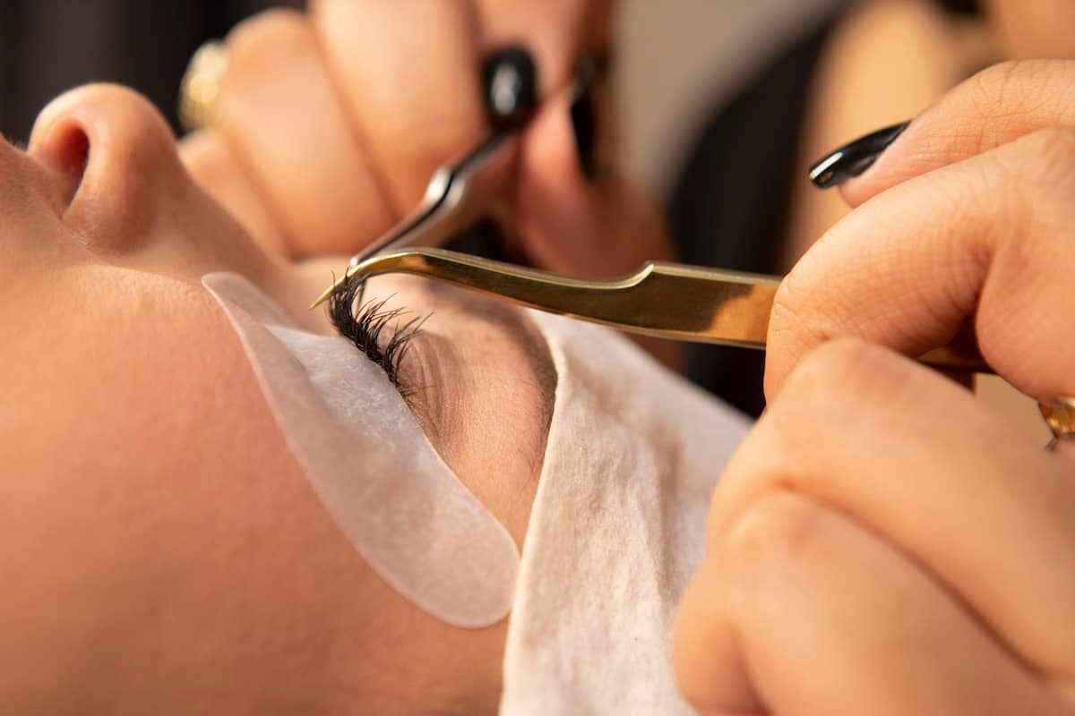 close up of lashes getting refilled by stylist at The Lash Lounge