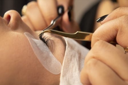 closeup of a woman getting her unique lash look filled at The Lash Lounge 