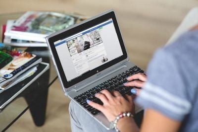 a woman typing on a laptop