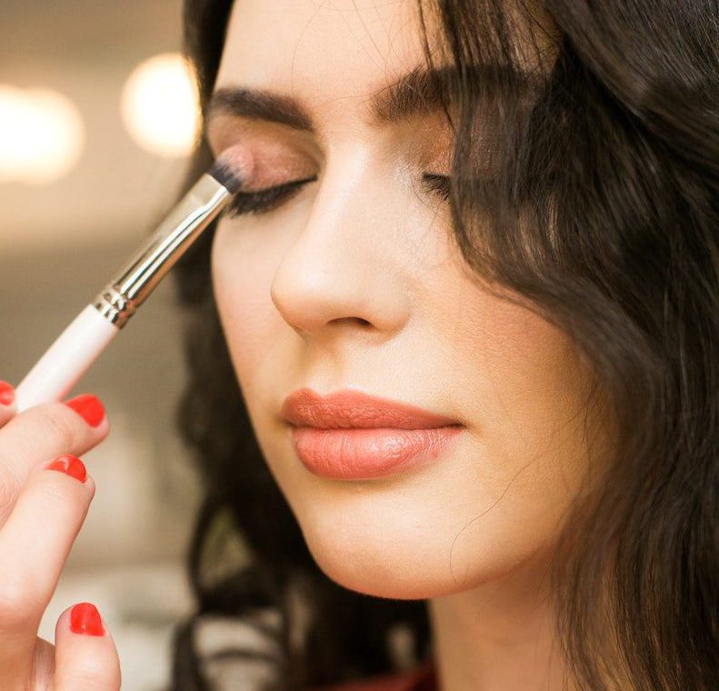 young woman applying makeup