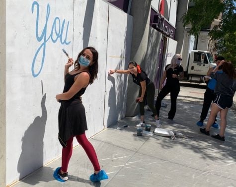 Staff from The Lash Lounge Chicago River North painting the exterior of the salon