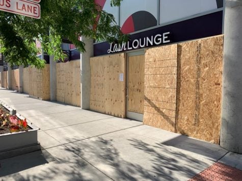 Exterior shot of The Lash Lounge  Chicago – River North boarded up after riots and break-in at their salon