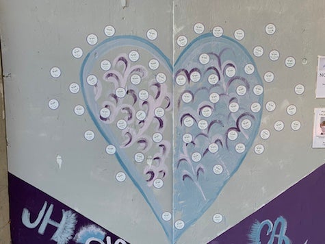 stickers placed by guests on the exterior mural outside of The Lash Lounge Chicago River North salon