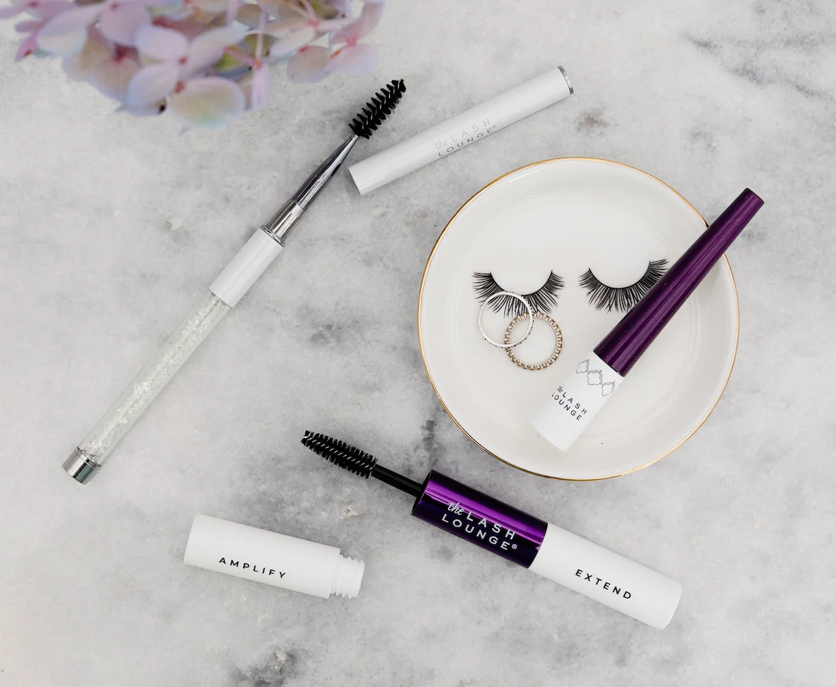 Bird's eye view shot of some of The Lash Lounge's retail products on a marble countertop