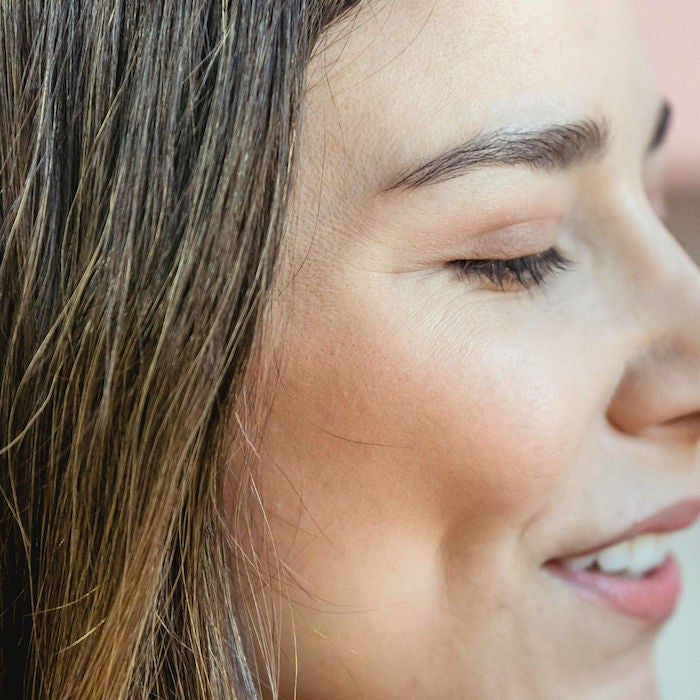 side close-up of a woman with tinted lashes