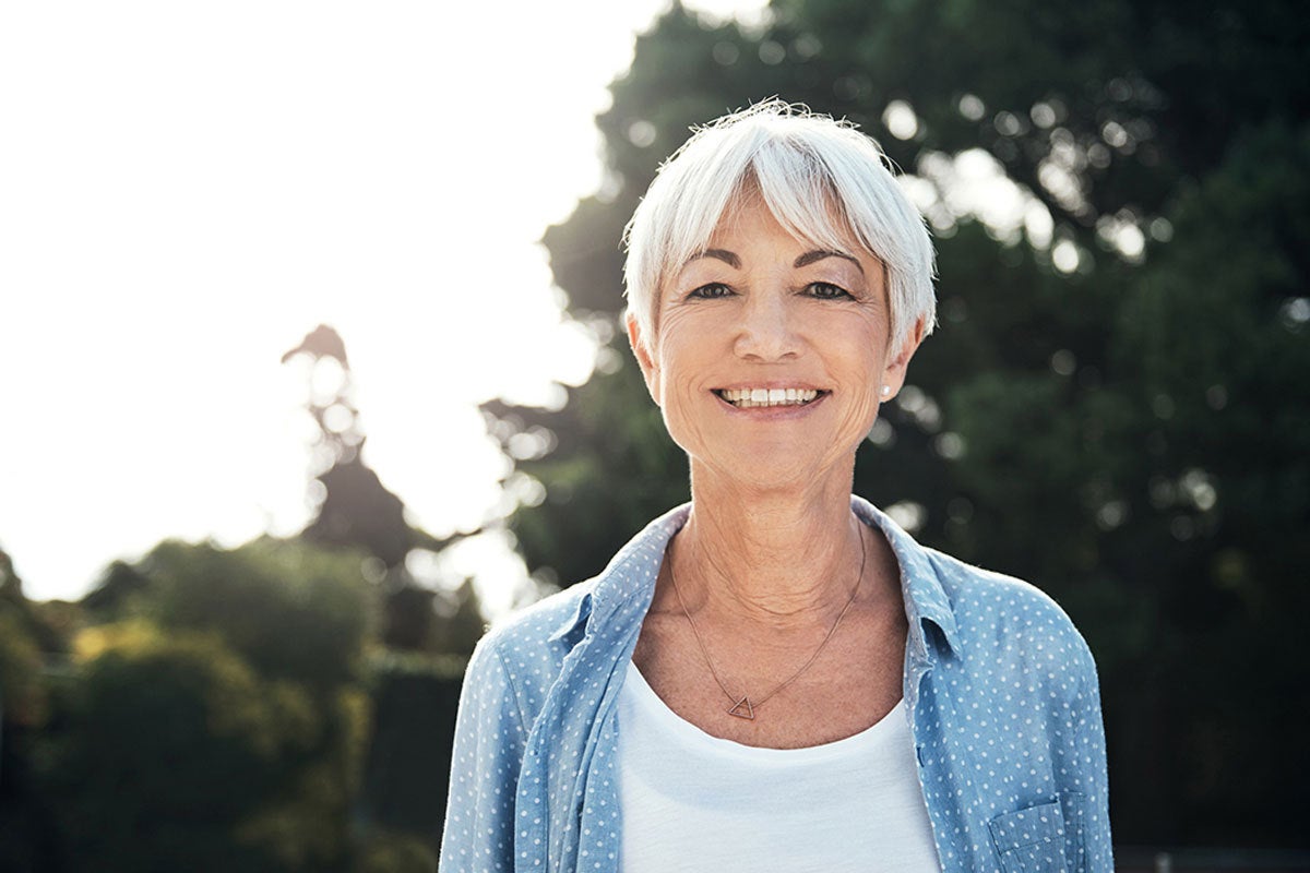 senior woman outside smiling after an eyebrow tint from The Lash Lounge