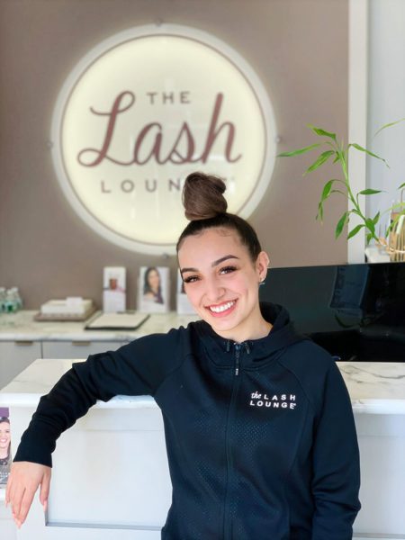 Lash Lounge stylist, Bianca, smiling in the front area of the salon.