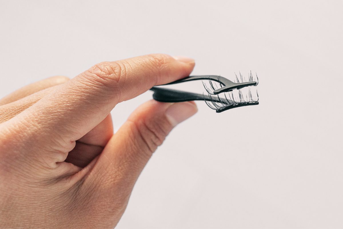 close up of hand holding magnetic lashes