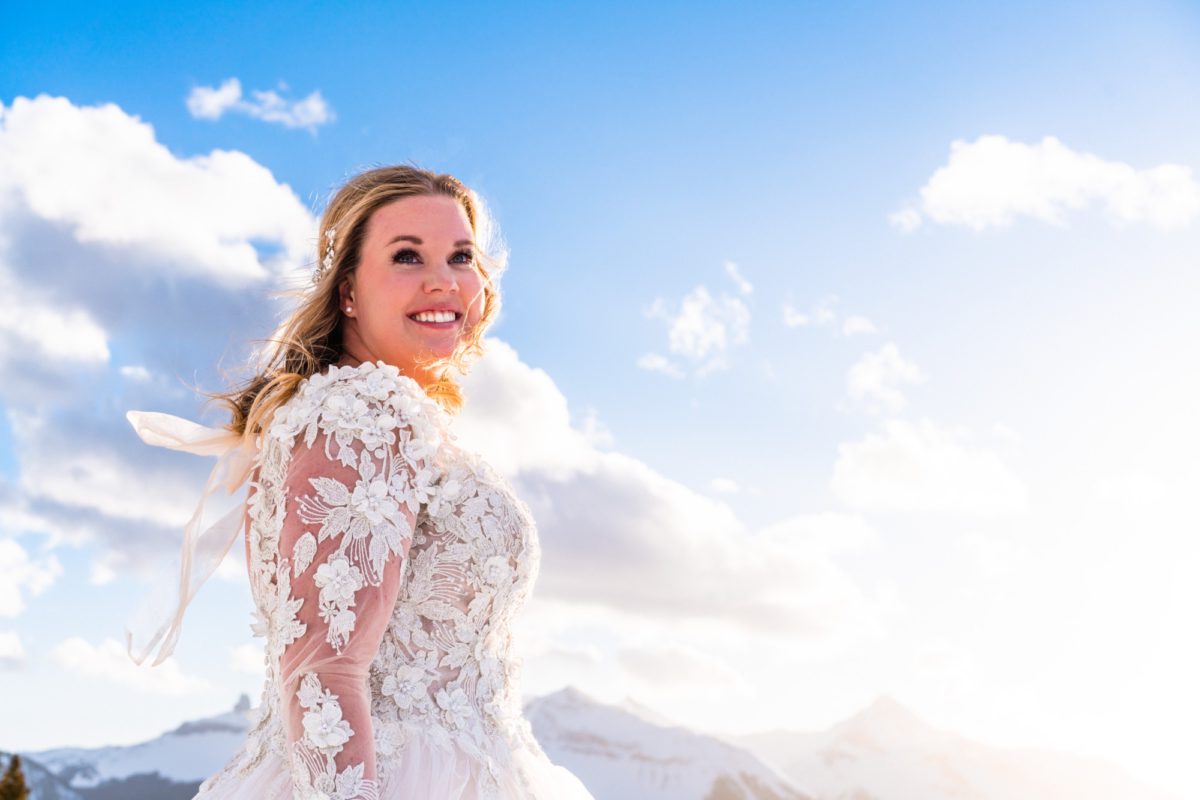 bride outdoors smiling with bridal eyelash extensions