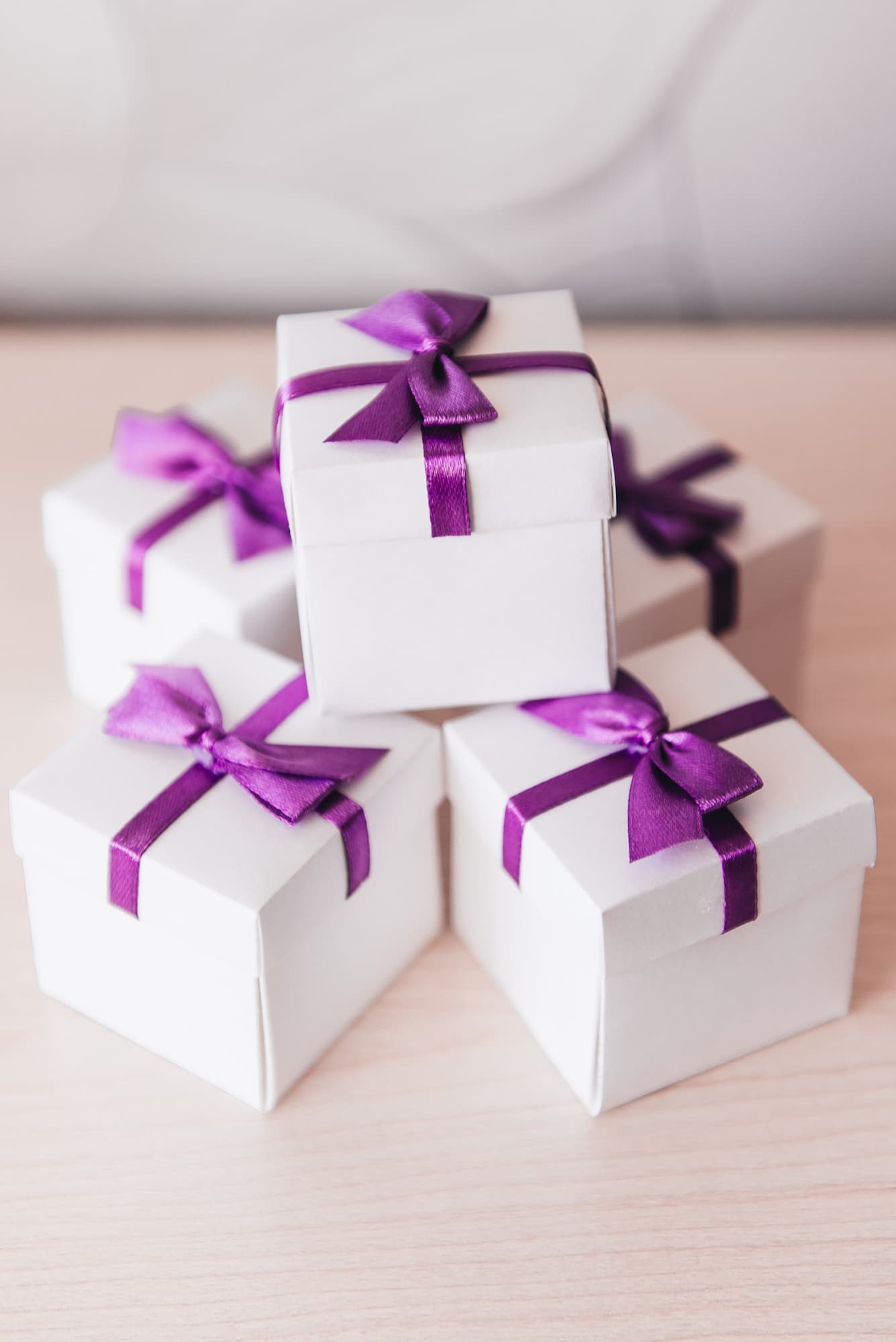 small white gift boxes stacked for wedding favors