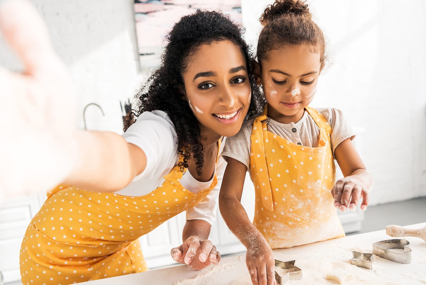 A woman and child spend quality time together in the kitchen