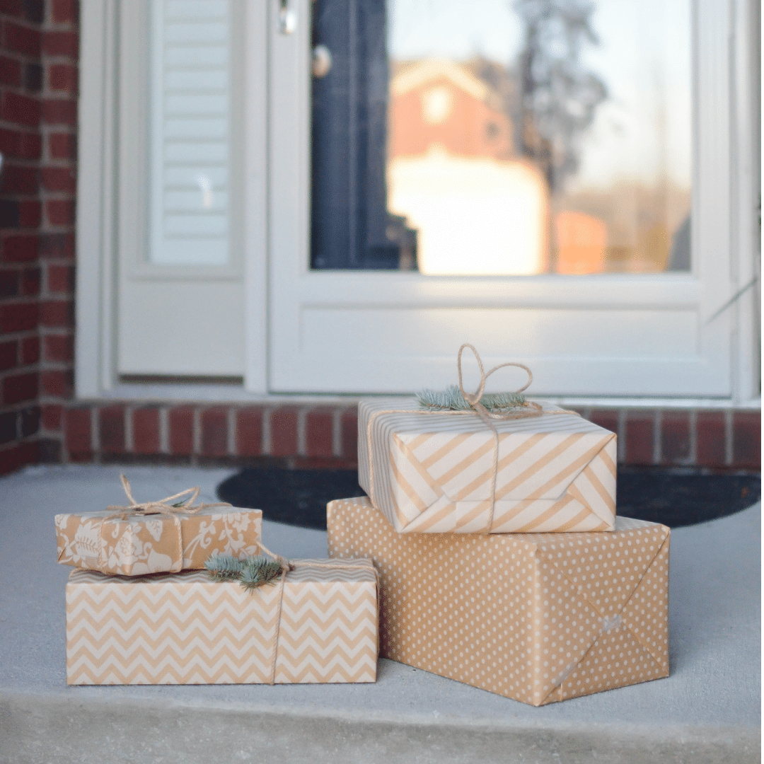 a stack of presents sitting on a door step