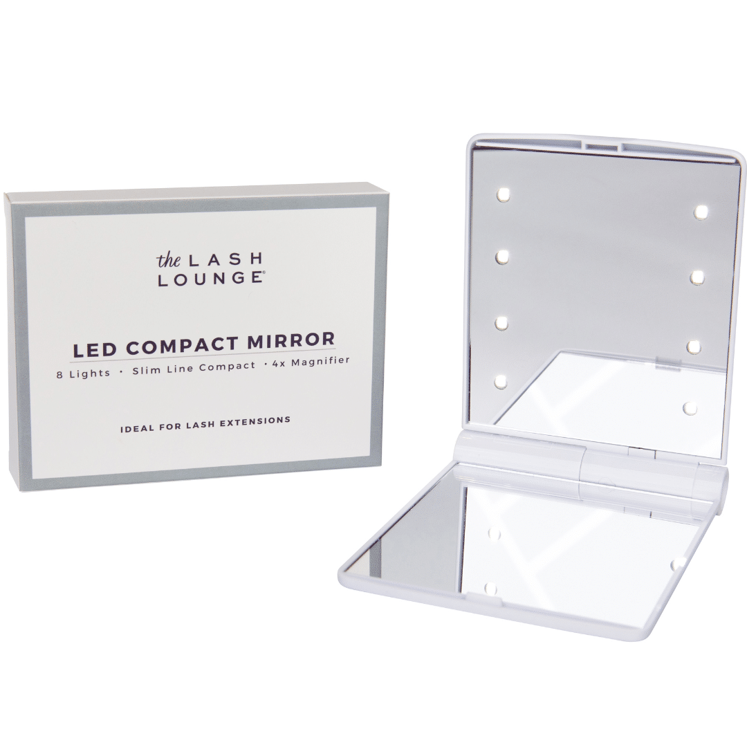 The Lash Lounge LED Compact Mirror open next to its white and gray packaging box