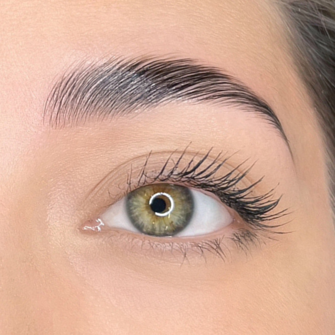 close-up of woman's open eye area after brow lamination