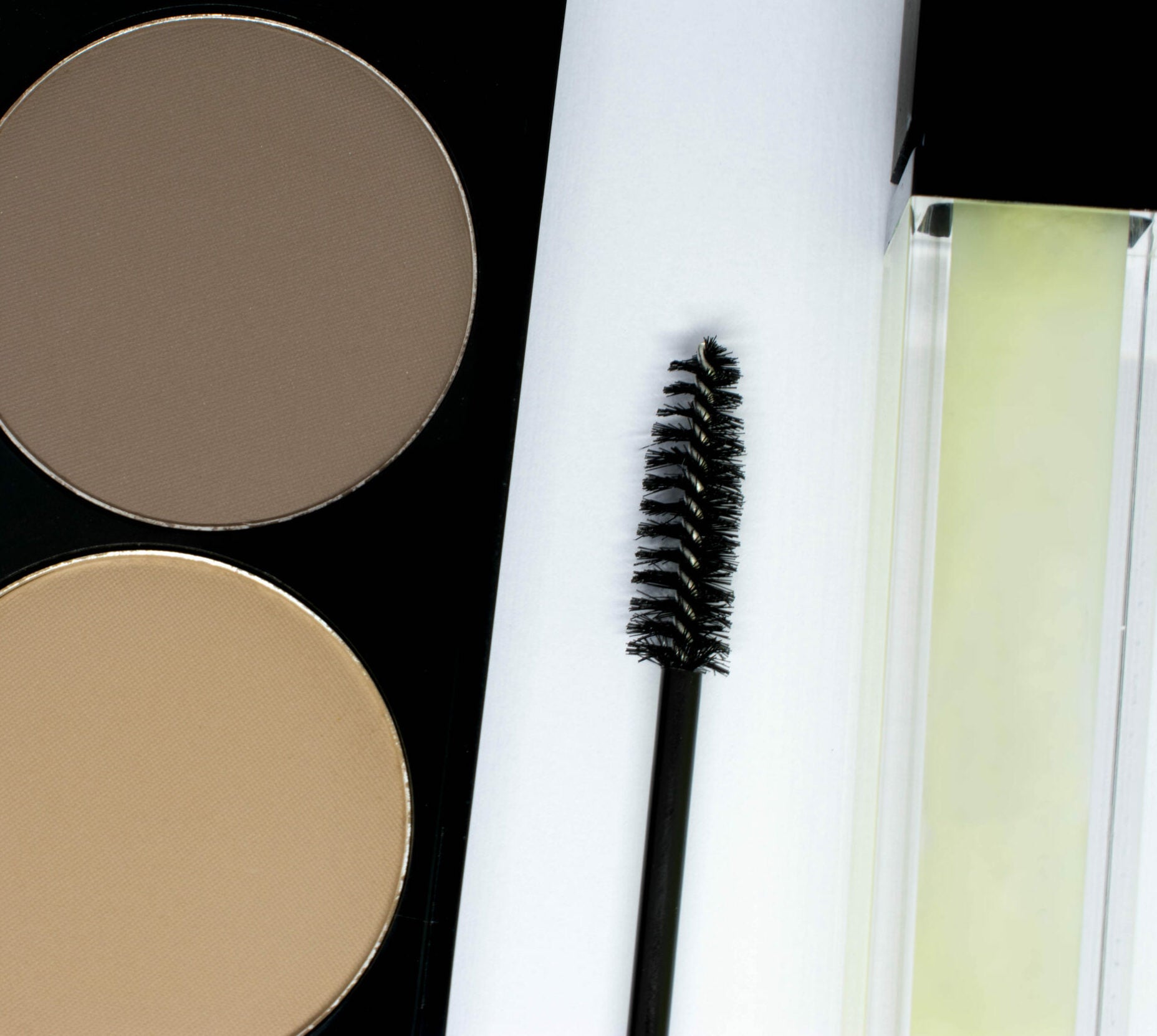 array of cosmetics for brows including brow powder, gel and comb