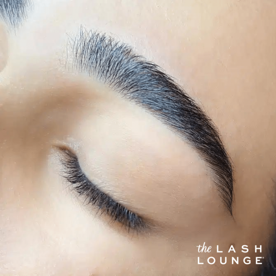 closeup of woman's eyebrow after shaped by brow threading