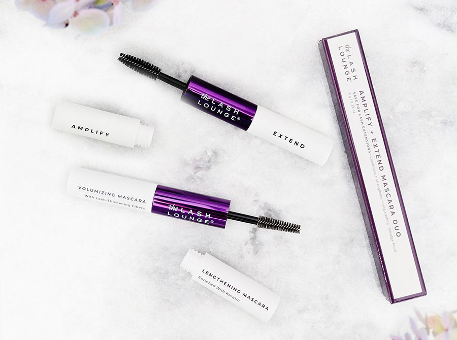 The Lash Lounge's Amplify + Extend Mascara Duo, product and box, laying down on a marble counter.