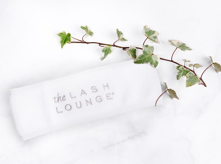 The Lash Lounge's Spa Headband laying down on a marble counter.