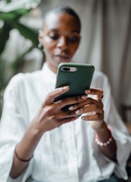 black woman looking at her cell phone